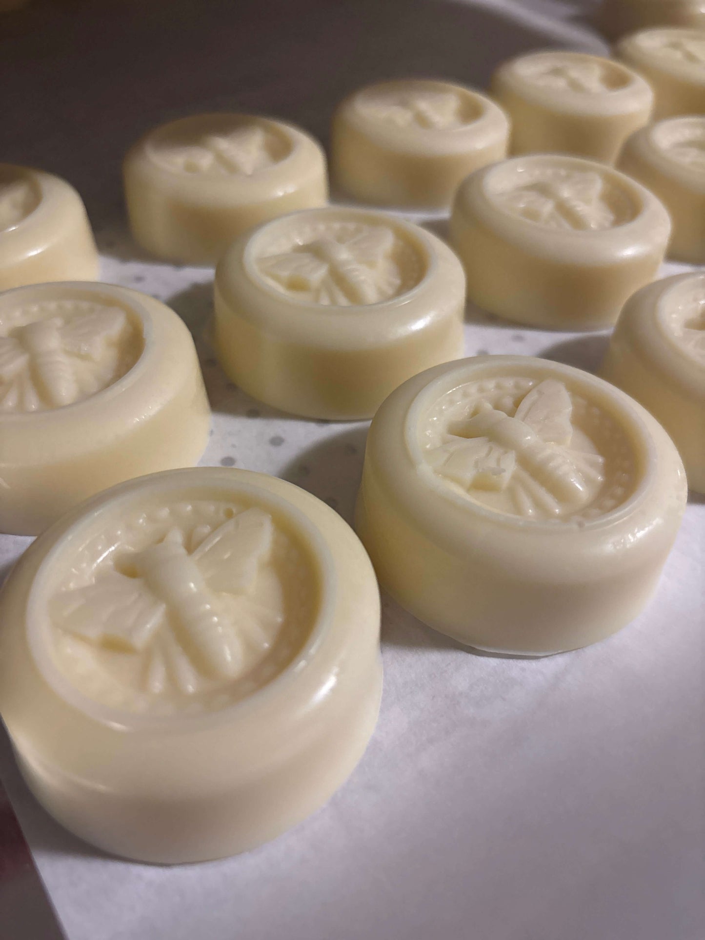 Close-up of solid lotion bars featuring embossed bee design, perfect for luxurious moisturizing and eco-friendly skincare.
