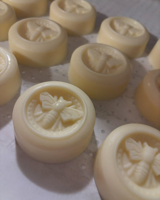 Freshly unmolded lotion bars resting on a tray