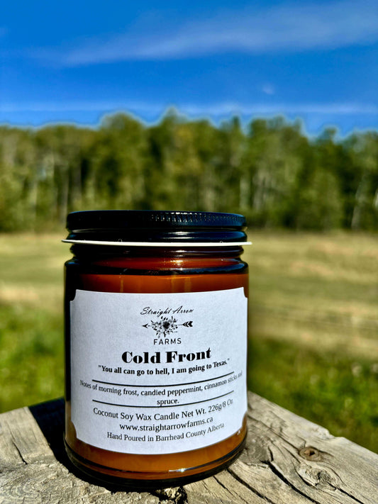Straight Arrow Farms wood wick candle in a glass jar on a rustic wooden surface