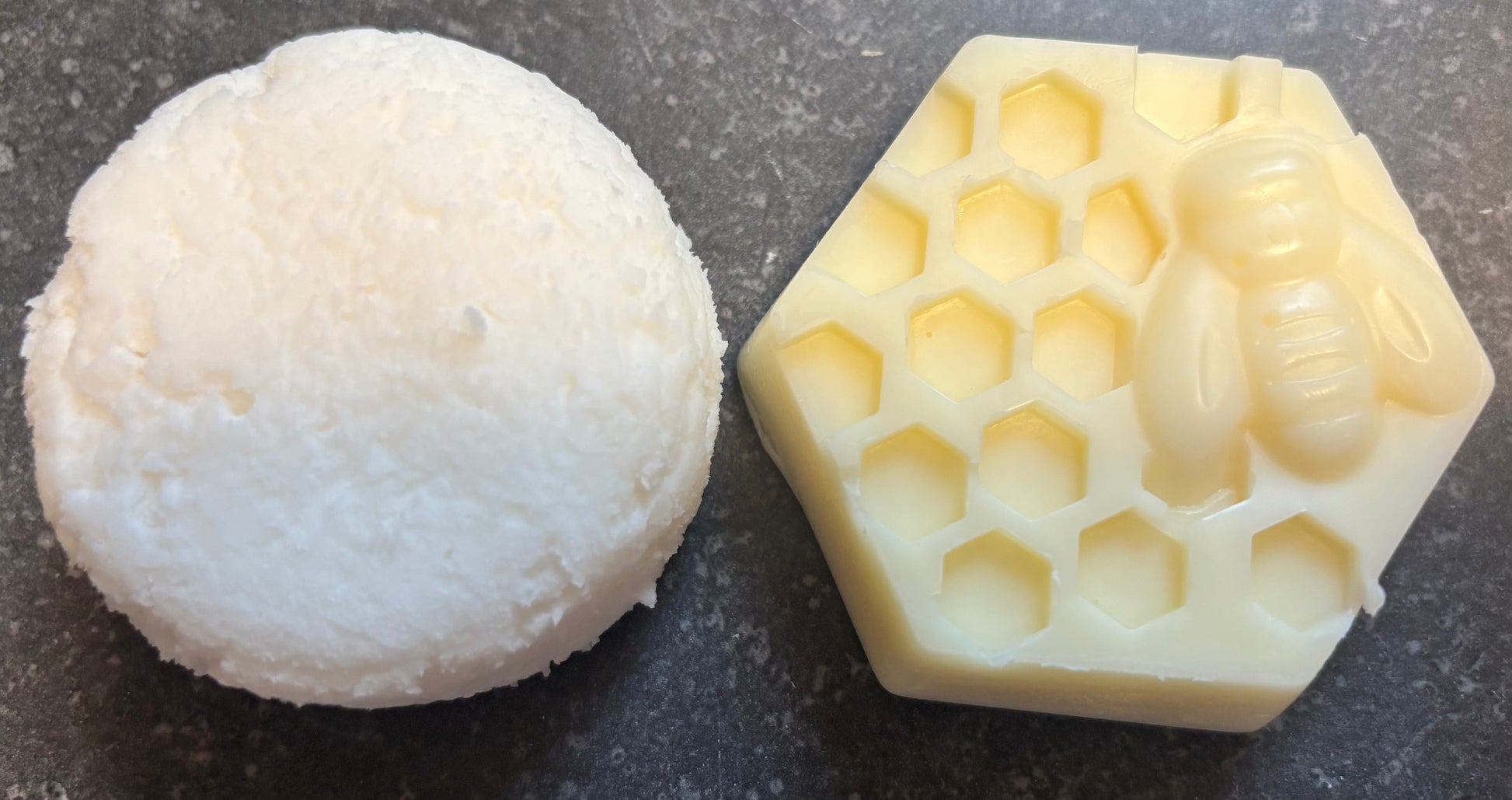 Hair Shampoo bar next to a hexagonal honeycomb-shaped hair conditioner bar on a dark surface. 