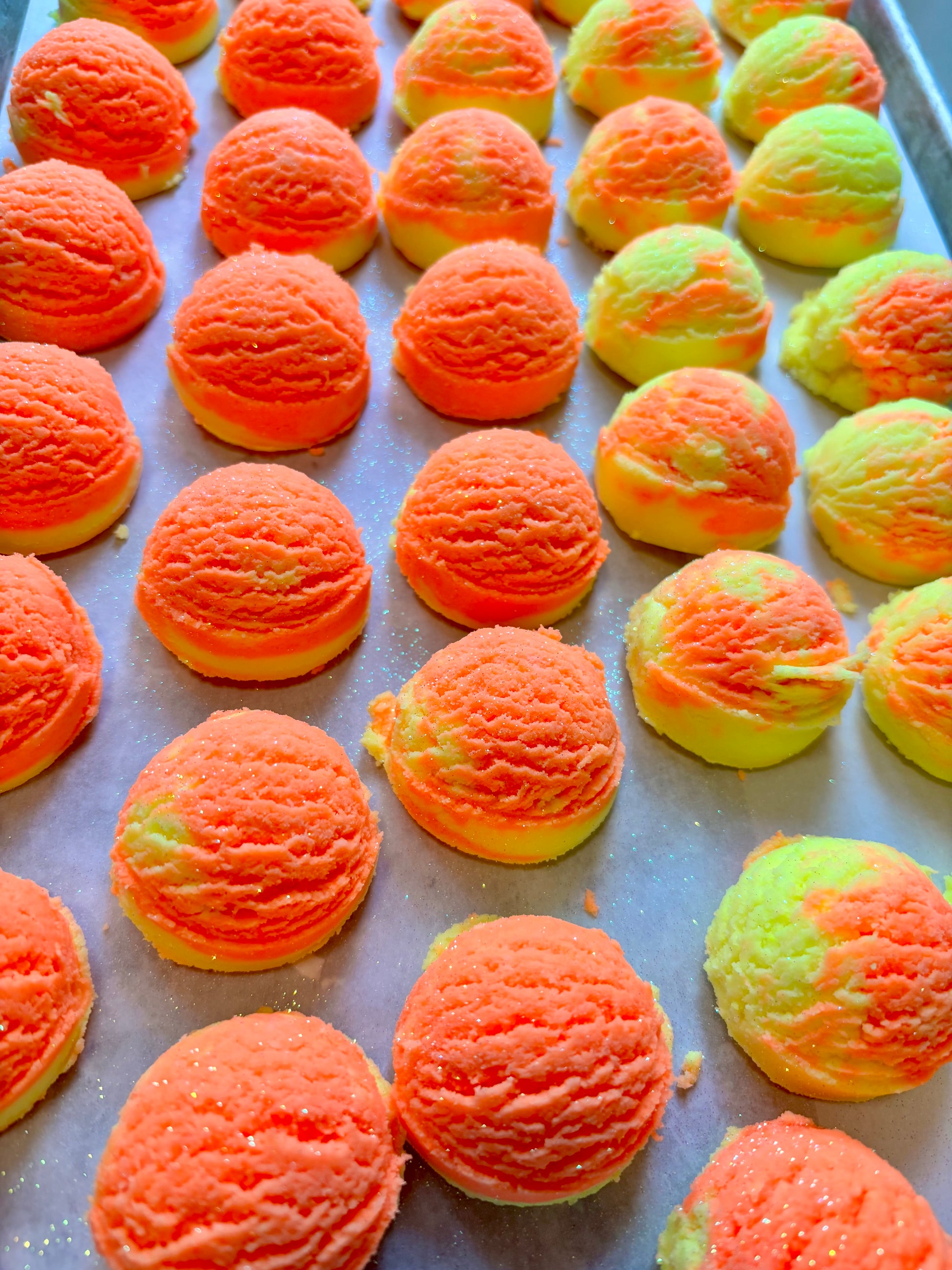 Colorful ice cream like scoops of solid bubble bath arranged on a tray. 