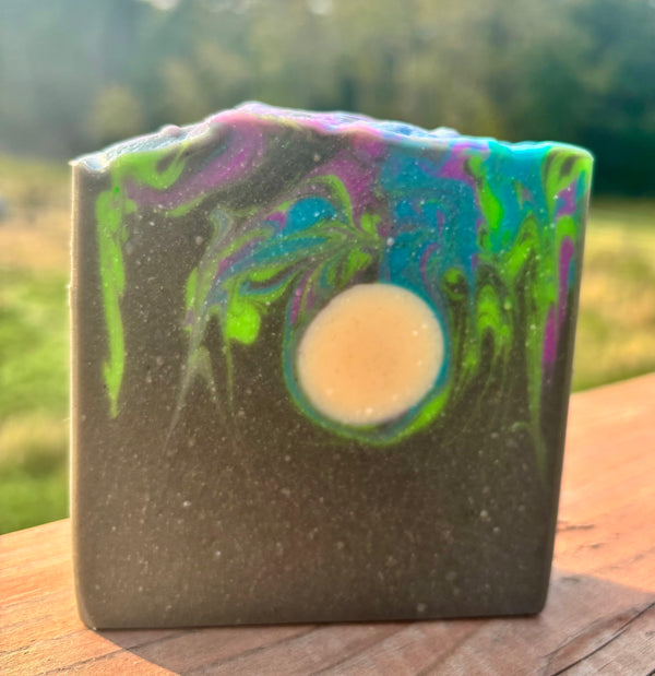 Colorful soap bar with a swirl pattern on a wooden surface