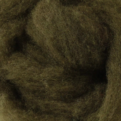 A basket containing multicolored wool dryer balls displayed outdoors with a scenic background.