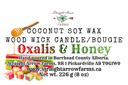 Coconut soy wax wood wick candle packaging with branding and product details, Oxalis + Honey scent.
